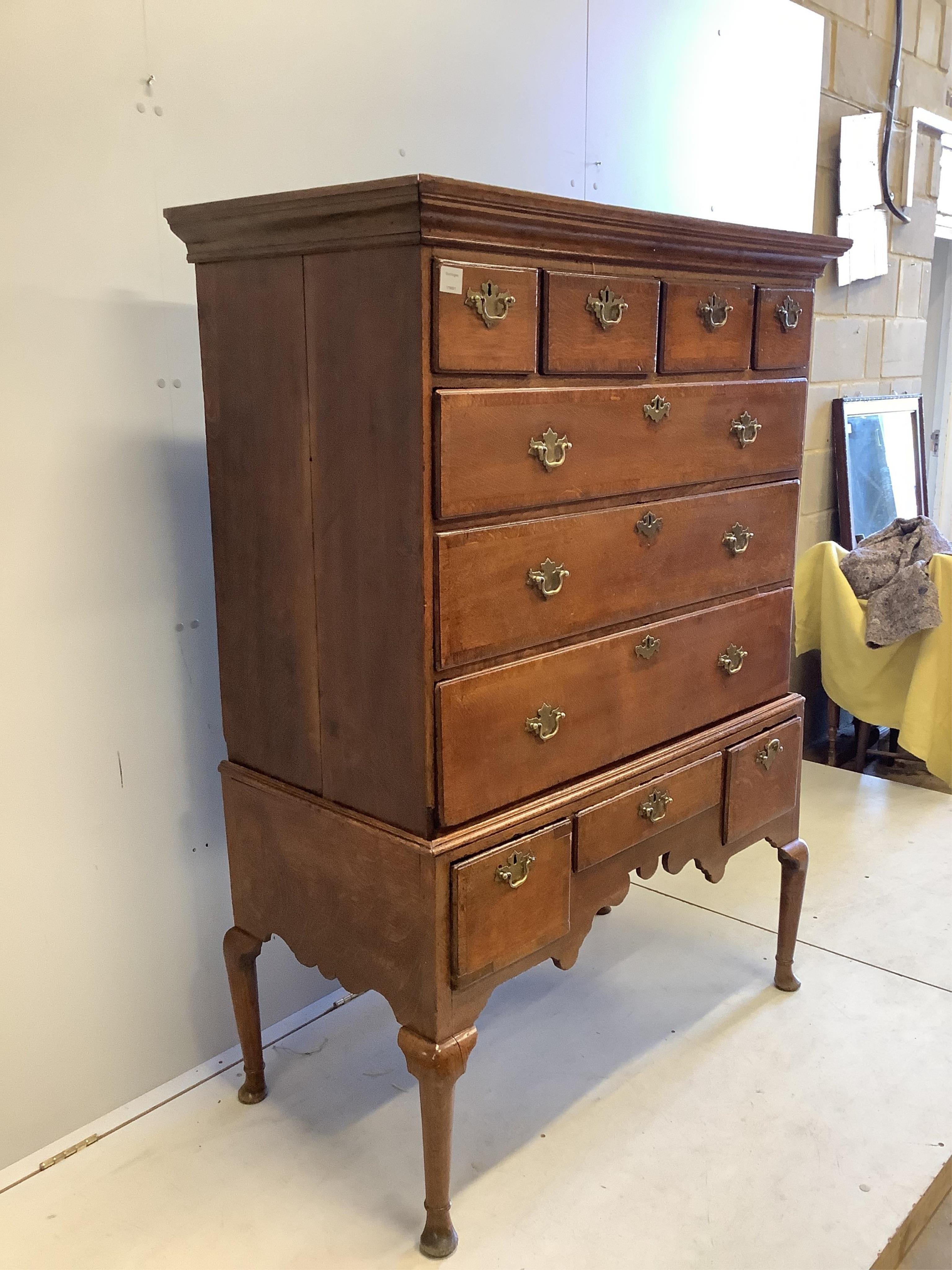 An 18th century banded oak chest on stand, width 114cm, depth 57cm, height 156cm